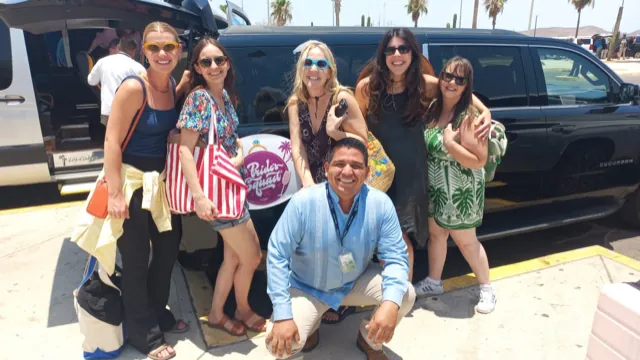 Bachelorette group and chauffeur in front of All Ways Suburban and Sprinter vans