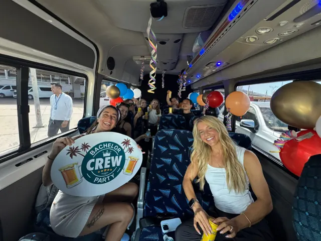 Celebrating inside an All Ways van with balloons on a Cabo party trip