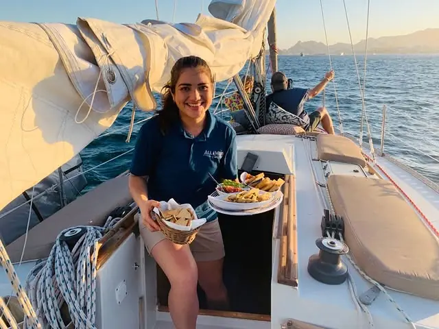 Crew serving fresh food at sunset
